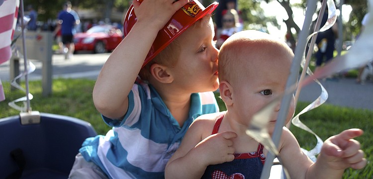 Colin Bankert, 3, kisses the head of his little sister, Giuliana, 1.
