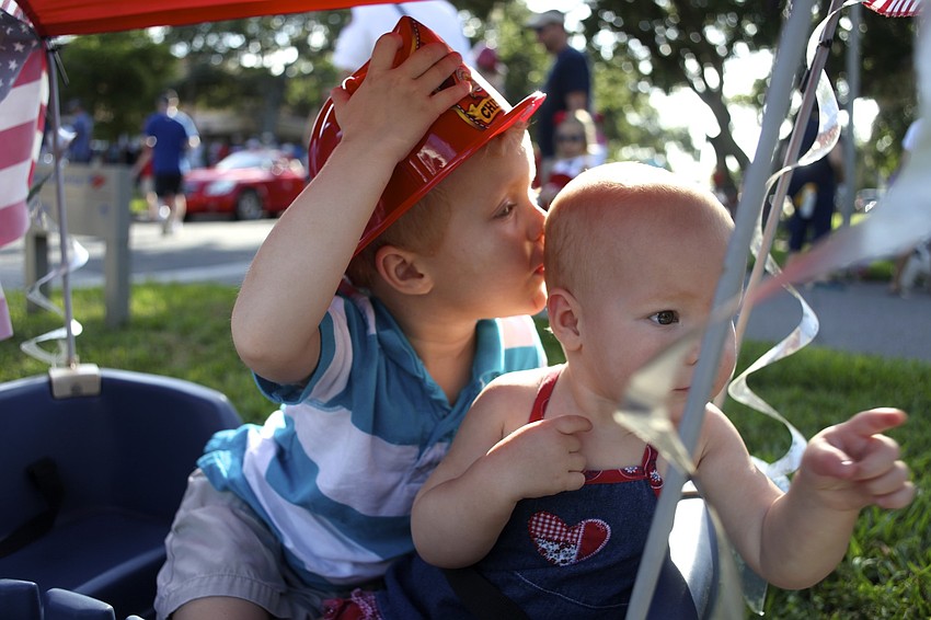 Colin Bankert, 3, kisses the head of his little sister, Giuliana, 1.