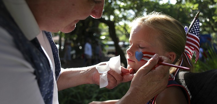 Karen Bell paints a patriotic picture on Anna Donnellanâ€™s face.