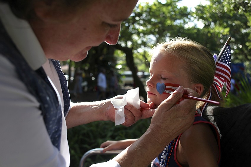 Karen Bell paints a patriotic picture on Anna Donnellanâ€™s face.