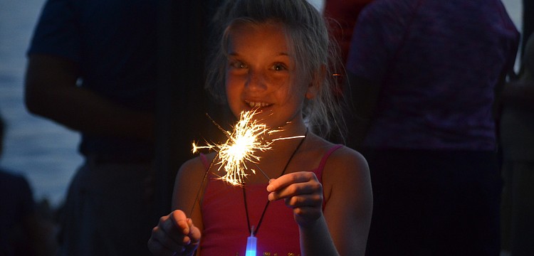 Kayla LaBlanc lights a sparkler.
