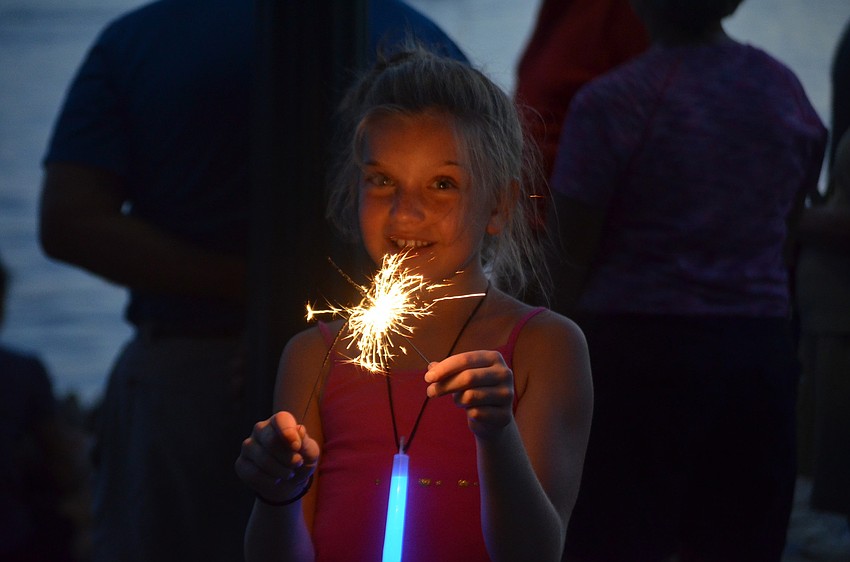 Kayla LaBlanc lights a sparkler.