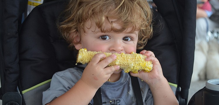 Weston Elken enjoys corn on the cob.