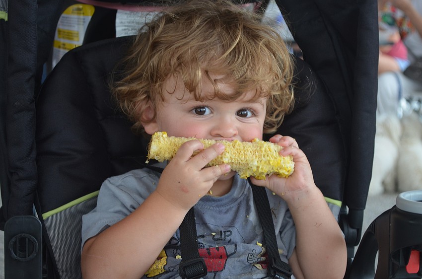 Weston Elken enjoys corn on the cob.