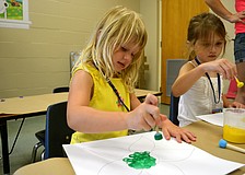 Marleigh Matras paints during craft time.