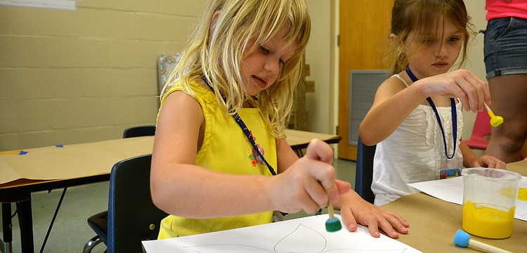 Marleigh Matras paints during craft time.