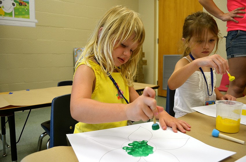 Marleigh Matras paints during craft time.