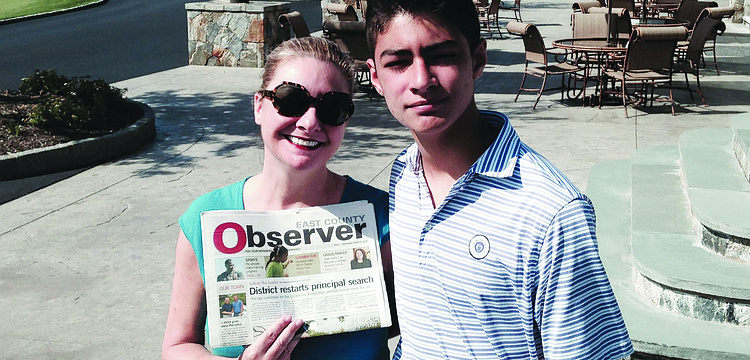 GOLF BUDDIES. Jessica Ortiz and her son, Tav, read their East County Observer at the Trump National Golf Club, in Westchester, N.Y.