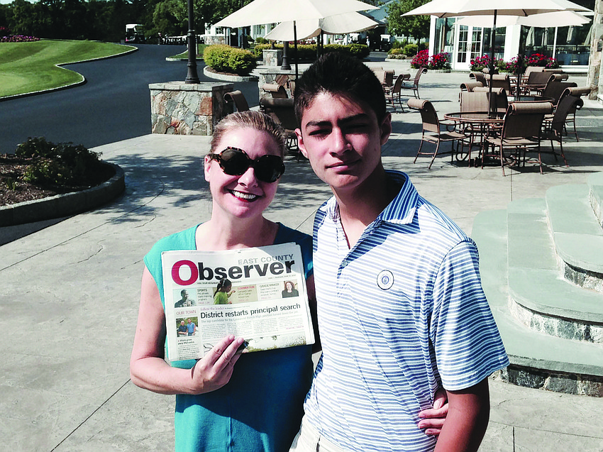 GOLF BUDDIES. Jessica Ortiz and her son, Tav, read their East County Observer at the Trump National Golf Club, in Westchester, N.Y.