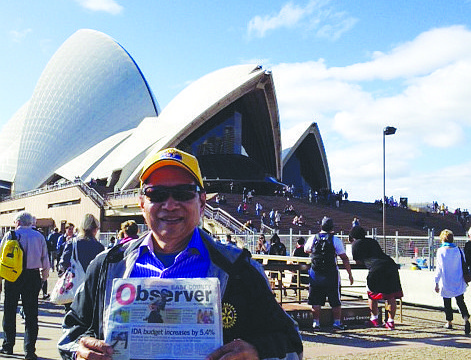 SOUND OFF. Lakewood Ranch resident Fred Lopez reads his East County news while enjoying the view of the Sydney Opera House, in Australia.