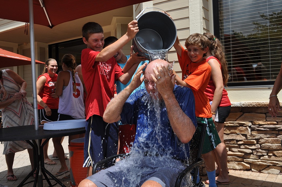 Children pour ice water over Dick Vitale.