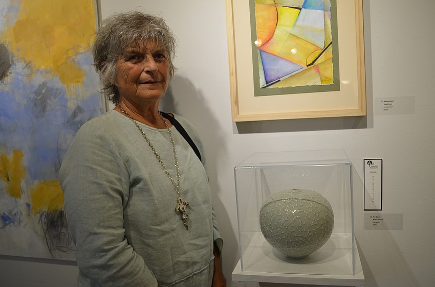 Robin MacKay poses with her award-winning porcelain bowl called 