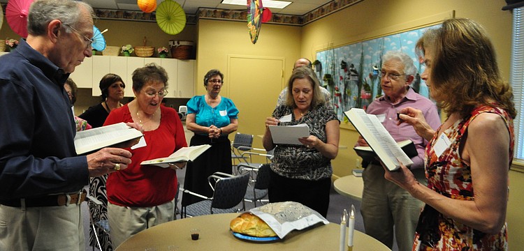 Attendees of the service say kiddish as they finish the Shabbat service.
