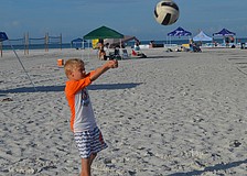Cade Strom passes the volleyball to his dad, Kyle.
