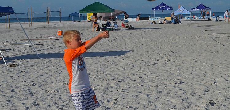 Cade Strom passes the volleyball to his dad, Kyle.