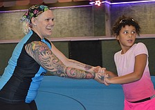 Christina â€œPinkyâ€ Williams helps Amelia Desha skate.