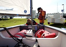 Jack Flovig, 8, prepares his optimist boat as Alex Berndt watches.