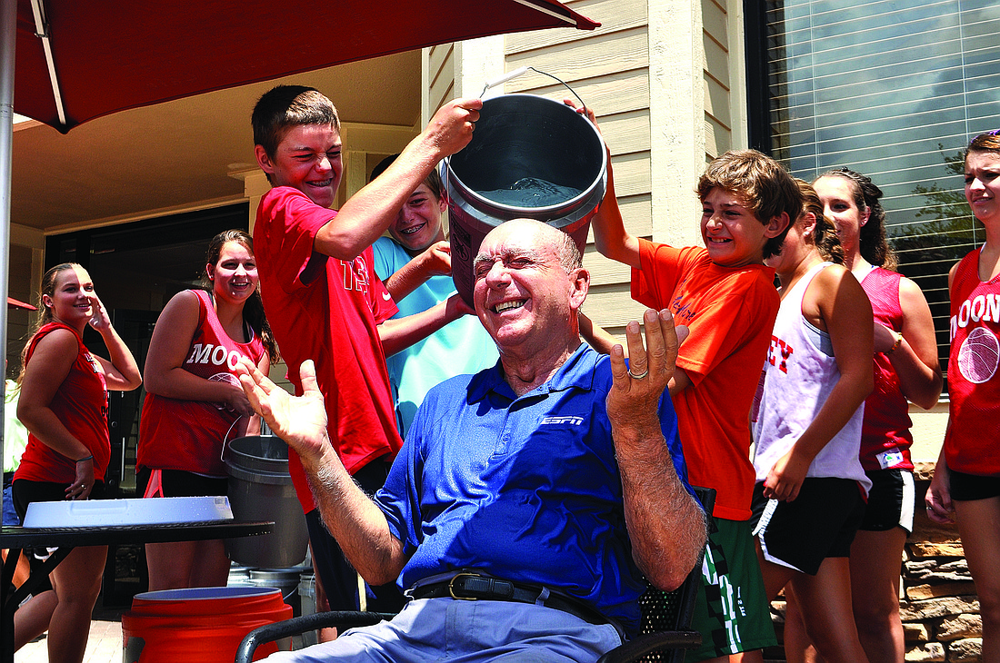Photo by Pam Eubanks Dick Vitale smiles after being doused with 30 buckets of cold water.