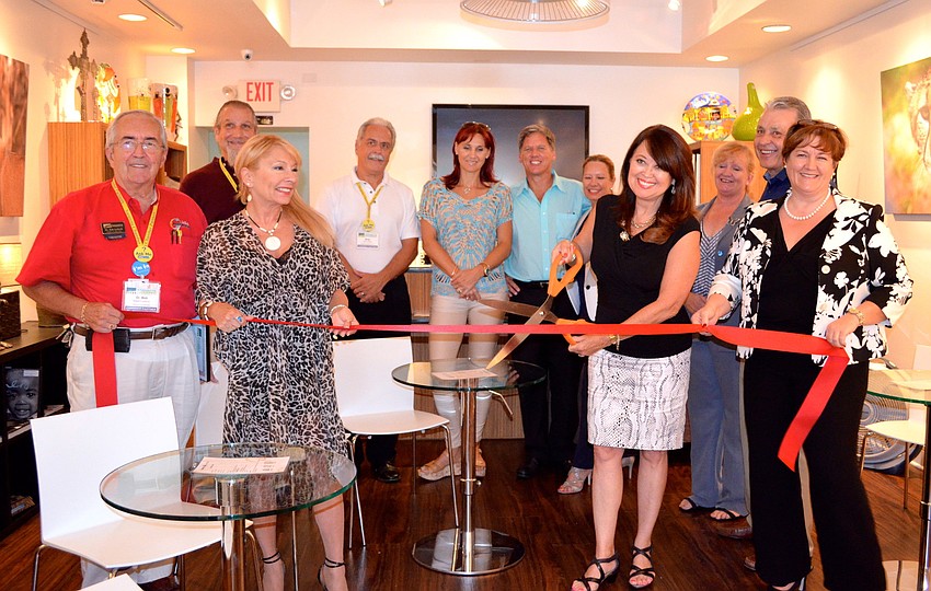 JoAnn Thomas, marketing manager at Touch of Africa, prepares to cut the ribbon in the new Hamba Lounge.