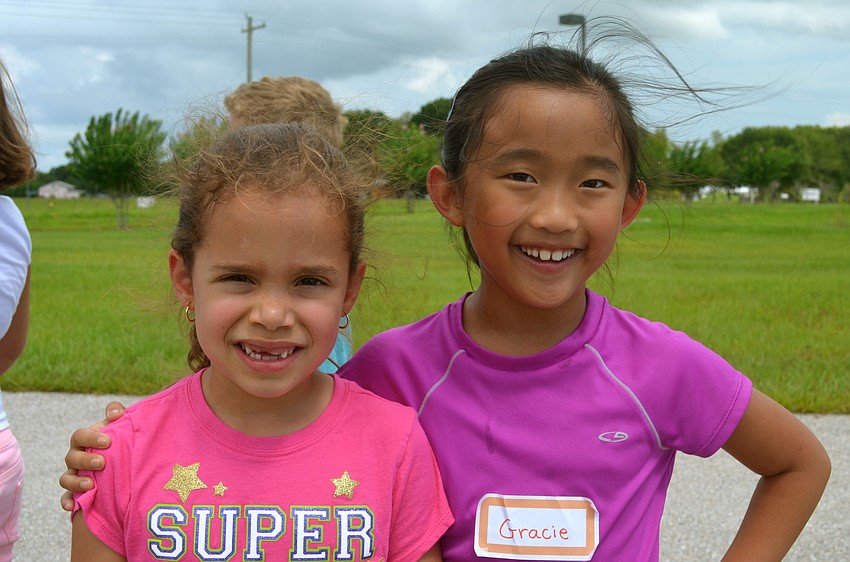 Victoria Santaella and Grace Lapointe take a break from kickball.