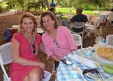 Jessica Bailey and Ashley Shultz sit at their family's picnic table.