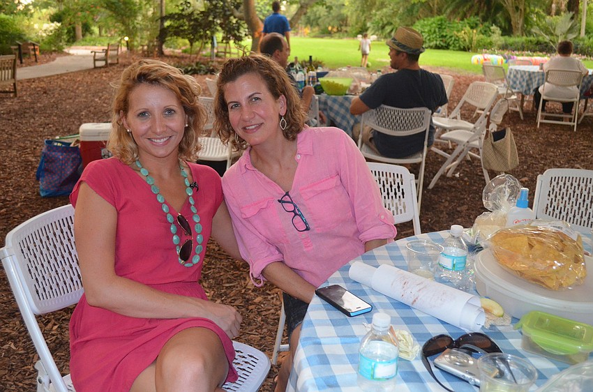 Jessica Bailey and Ashley Shultz sit at their family's picnic table.