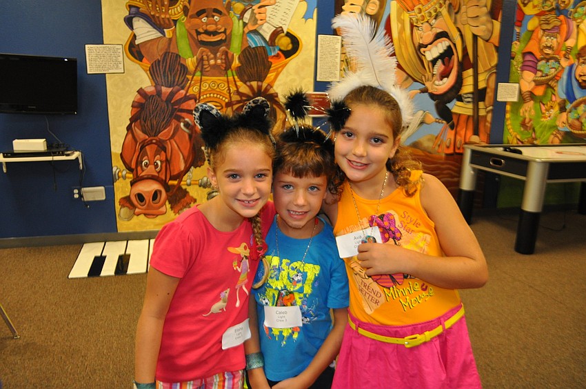 Siblings Elisha, Caleb and Ava Light all don animal-themed headgear.