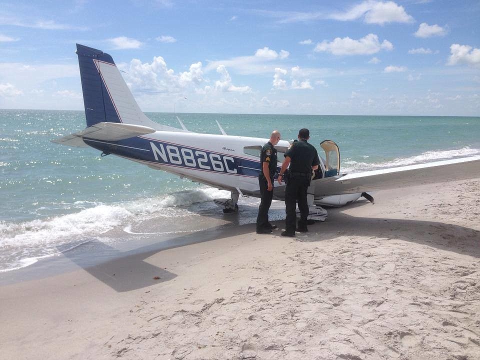 Sarasota County deputies investigate the scene of a plane crash on Caspersen Beach Sunday.