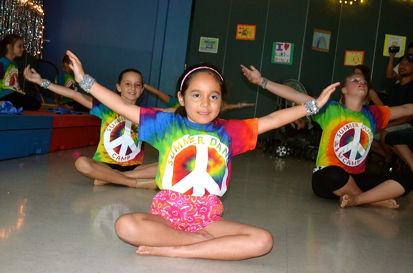 Sofia Flores leads the group in dance.