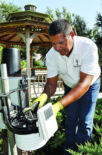 Landscape Supervisor Ramone Sepulveda checks a weather station in Lakewood Ranch. Photo by Pam Eubanks