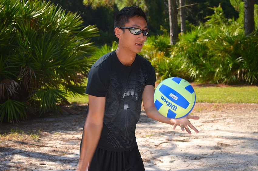 Chen Li serves the volleyball.