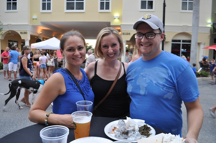 Katya Prokopenko and Annie and Alex Breitinger enjoy drinks together.