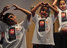 Corbin Merriott and Roman Haught remember all the actions for the songs.