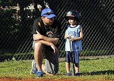 Five-year-old Landon Marshall receives some last minute advice from his father, Steve, before stepping into the batterâ€™s box.
