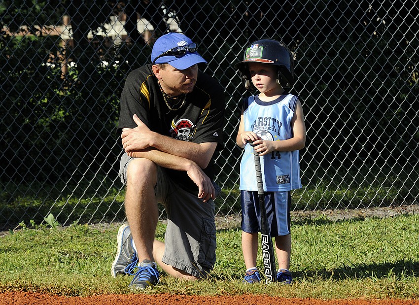 Five-year-old Landon Marshall receives some last minute advice from his father, Steve, before stepping into the batterâ€™s box.