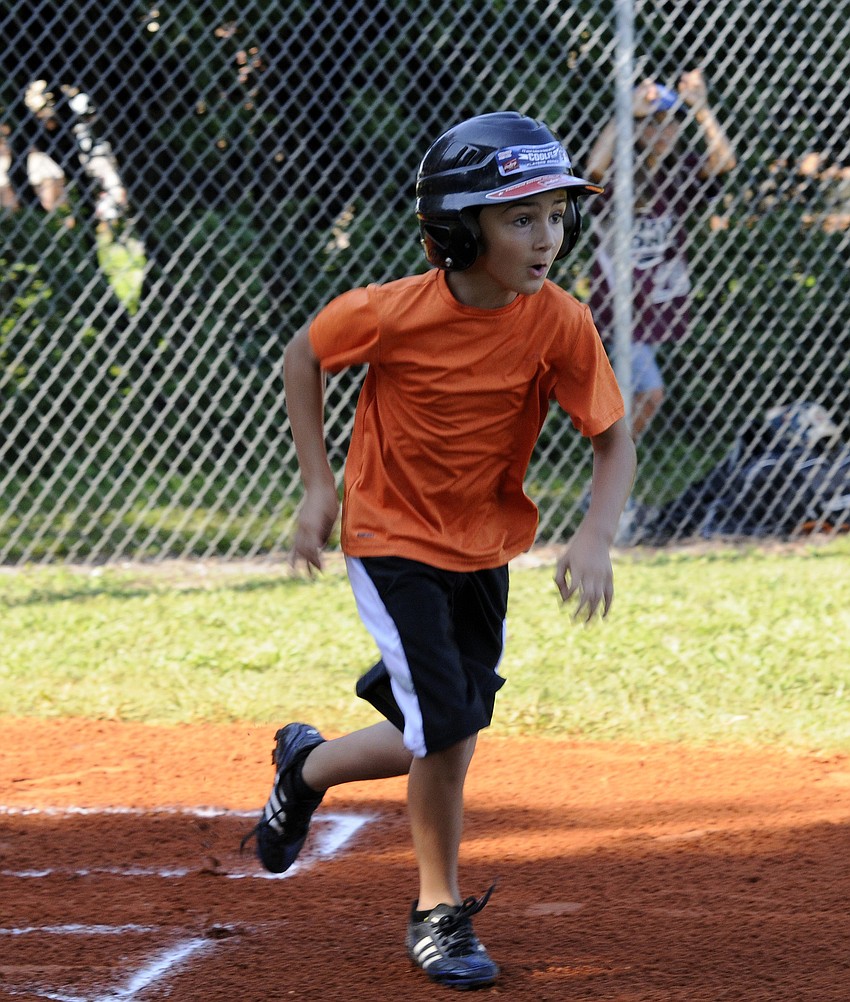 Silas McKellar, 8, races down the first base line.