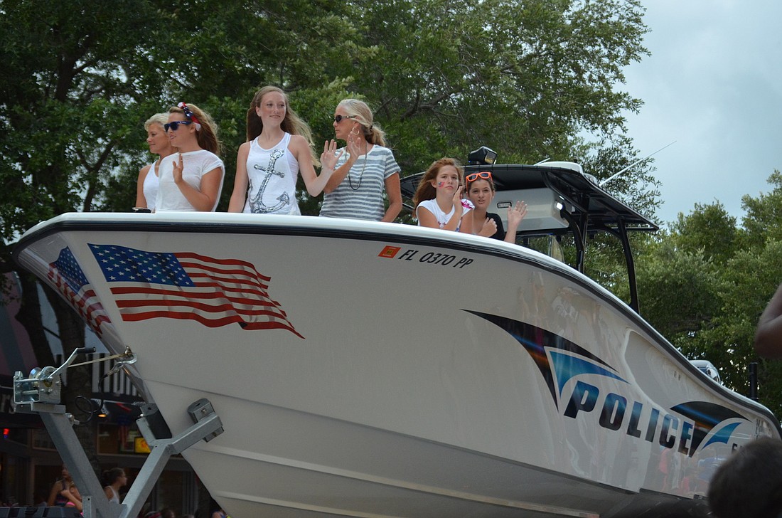 A Sarasota Police Department boat cruises in the Suncoast Super Boat Grand Prix parade last month.