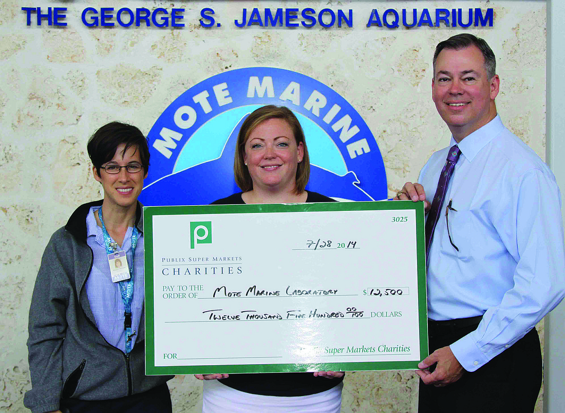 Courtesy photo Hayley Rutger and Aly Busse, of Mote Marine Laboratory, receive a check from Brian West, of Publix.