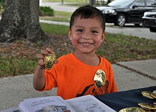 Gabriele Orcoc is excited to get a Junior Police Officer of Sarasota badge at National Night Out Against Crime.