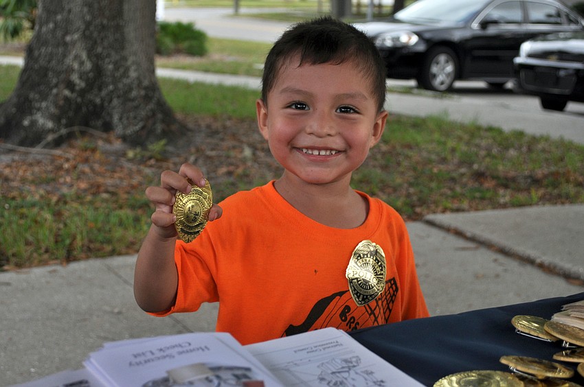 Gabriele Orcoc is excited to get a Junior Police Officer of Sarasota badge at National Night Out Against Crime.