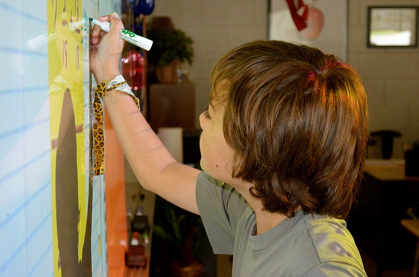 Josh Siegel solves a math problem for points for his team.