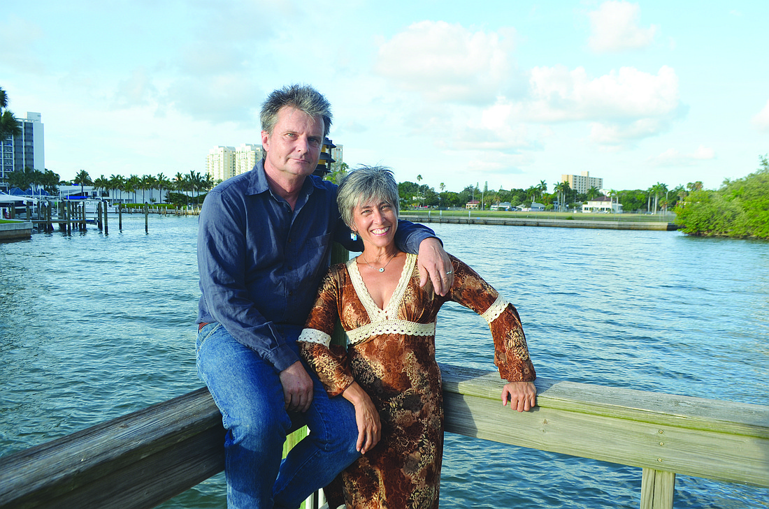 Achim and Erika Ginsberg-Klemmt stand on the dock a Lawrence Pointe property owner built in 1994. The ownership of the dock, and of the land it sits on, has been questioned by the coupleÃ¢â‚¬â„¢s neighbors. Photo by David Conway