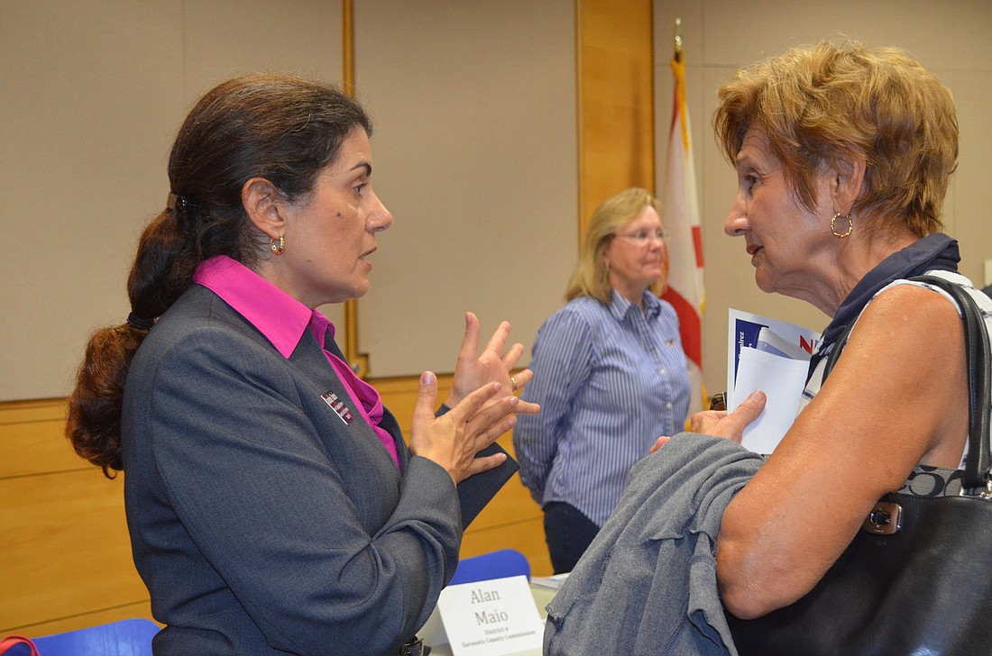 County Commission candidate Lourdes Ramirez speaks with Loretta Friedman.