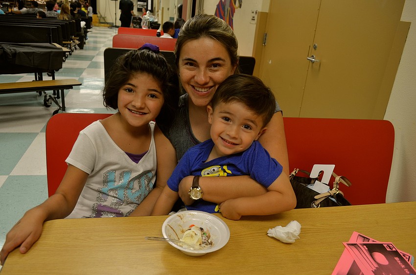 Gabriella Ramirez, Luz Barrero and Marthin Ramirez snack on ice cream.