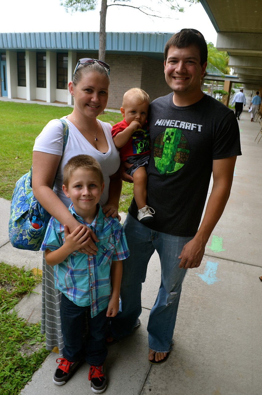 Tahnee, Korbin and Tyler Wampler walk the school's campus with Kayden Parker after ice cream.