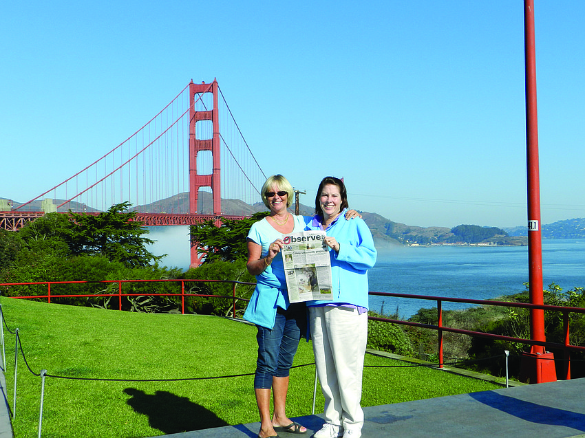 GOLDEN GIRLS. Christina Filkins and Tory Newman read their Longboat Observer news in front of the Golden Gate Bridge in San Francisco.