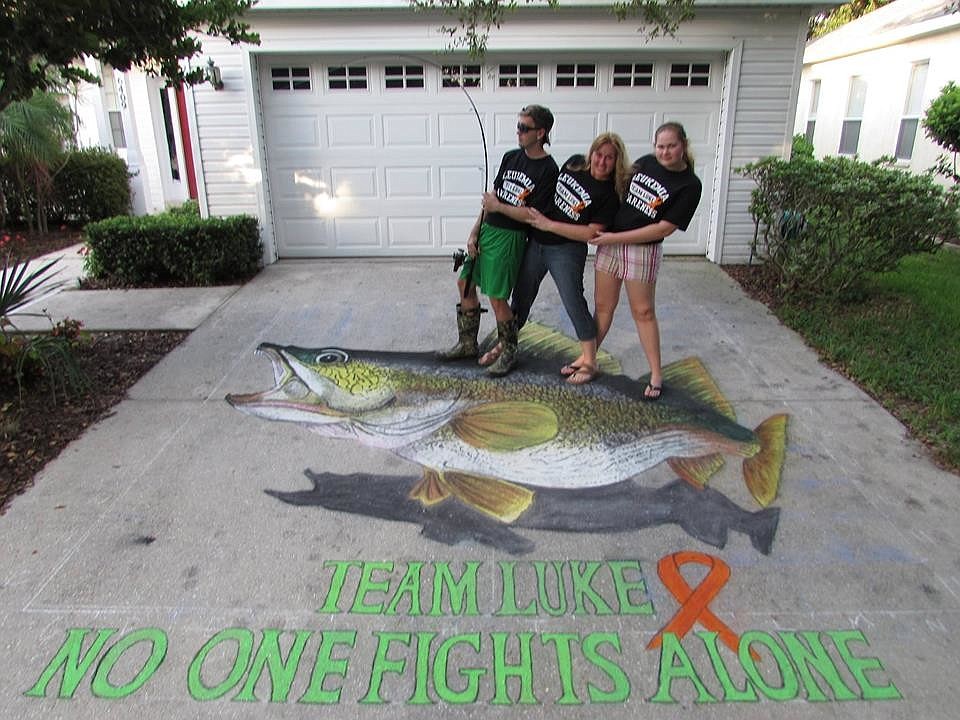 Nigel, Michelle and Ava Clinton, of Lakewood Ranch, reel in a walleye for their relative.