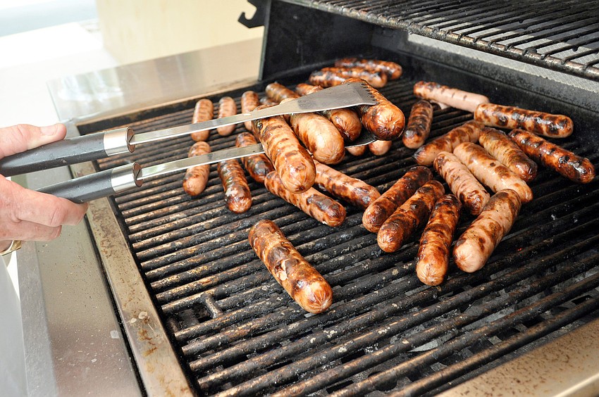 Jim McGuire mans the grill at St. Mary Menâ€™s Clubâ€™s Hot Dog Cookout.
