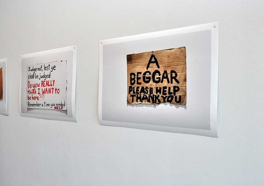 Sally Pettibonâ€™s â€˜Flying a Signâ€™ exhibition at Two Columns Gallery features photographs of unique signs from people asking for money on the side of the street.