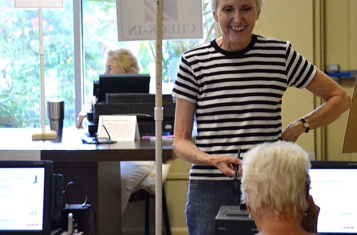 Janet Andres, a Manatee County resident from Longboat Key, casts her vote at the Longboat Island Chapel Tuesday morning.